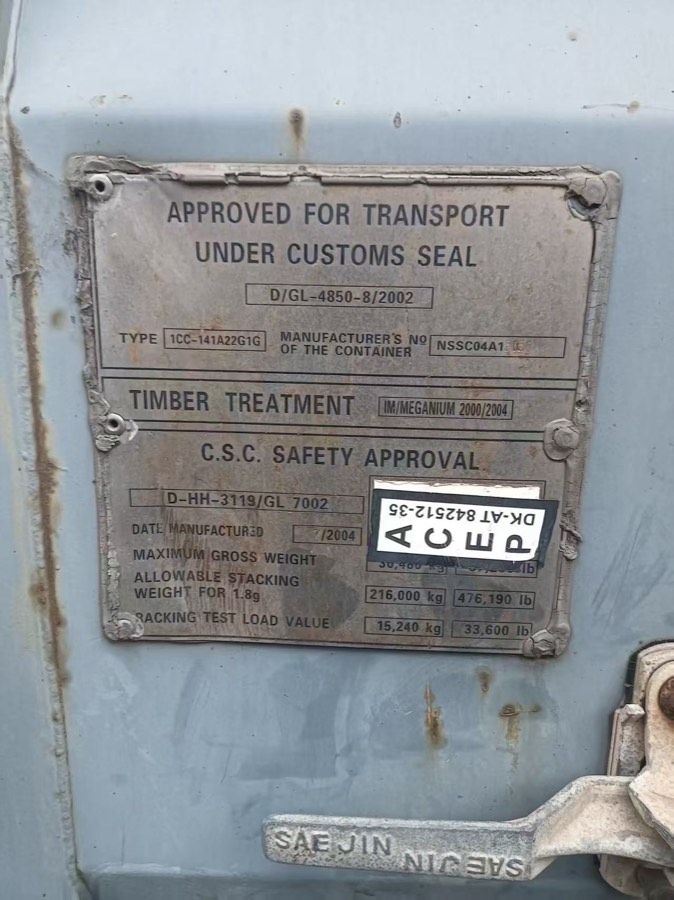 A CSC safety approval plate riveted to a container door, showing the approval reference, date of manufacture, maximum gross weight and racking test load values.